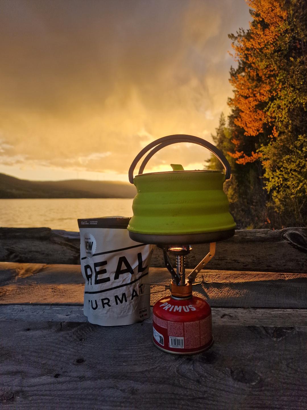 My cooking equipment with the sun setting behind it.